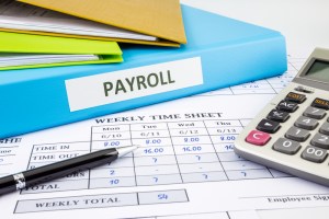 Weekly timesheet and payroll paperwork and binders