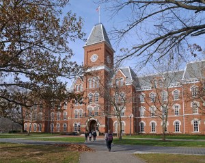 Brick building at a college campus with students walking