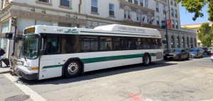 AC Transit bus stopped at traffic signal.